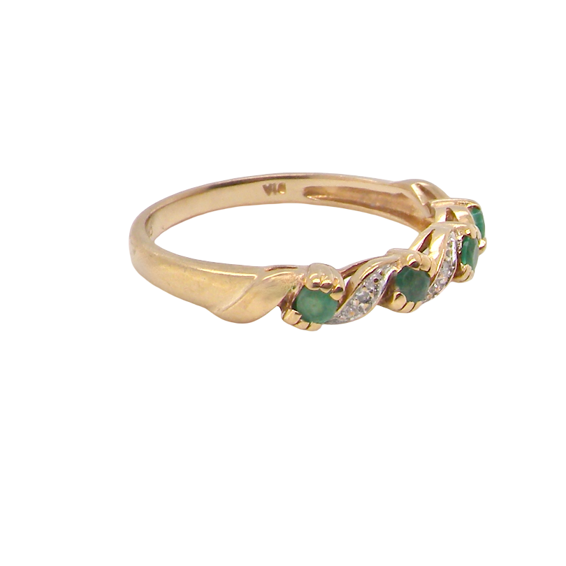 A 9 carat gold half hoop eternity ring. Set with four 2.4mm emeralds.
Set in alternate sections, a 'lazy S' design, side