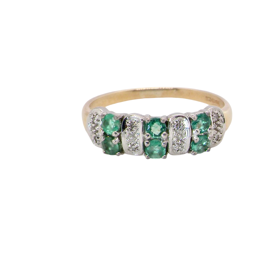 A 9 carat gold half hoop ring. Set with six round emeralds 3mm each,(total 0.35 carats est) and interspaced with vertical white gold sections each set with 1mm diamonds.(0.05 carats est)