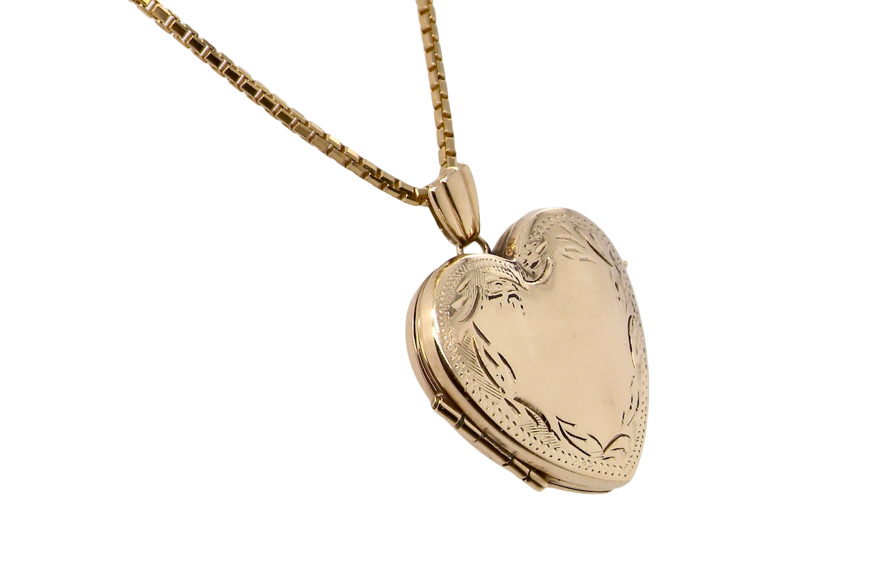 A 9 carat gold heart shaped locket. 25x25mm, part hand engraved front,