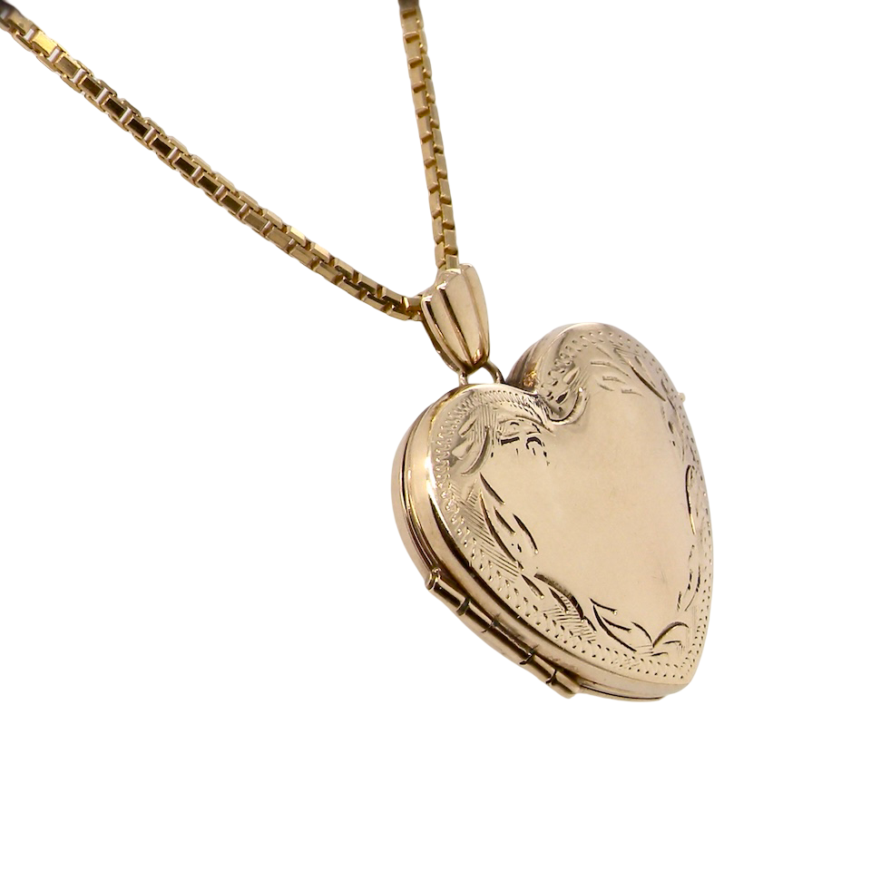 A 9 carat gold heart shaped locket. 25x25mm, part hand engraved front,