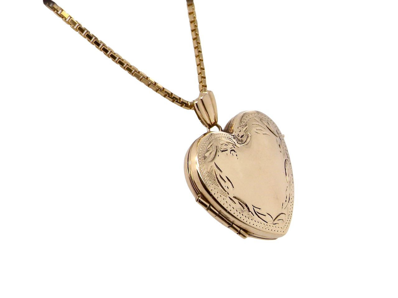 A 9 carat gold heart shaped locket. 25x25mm, part hand engraved front,
