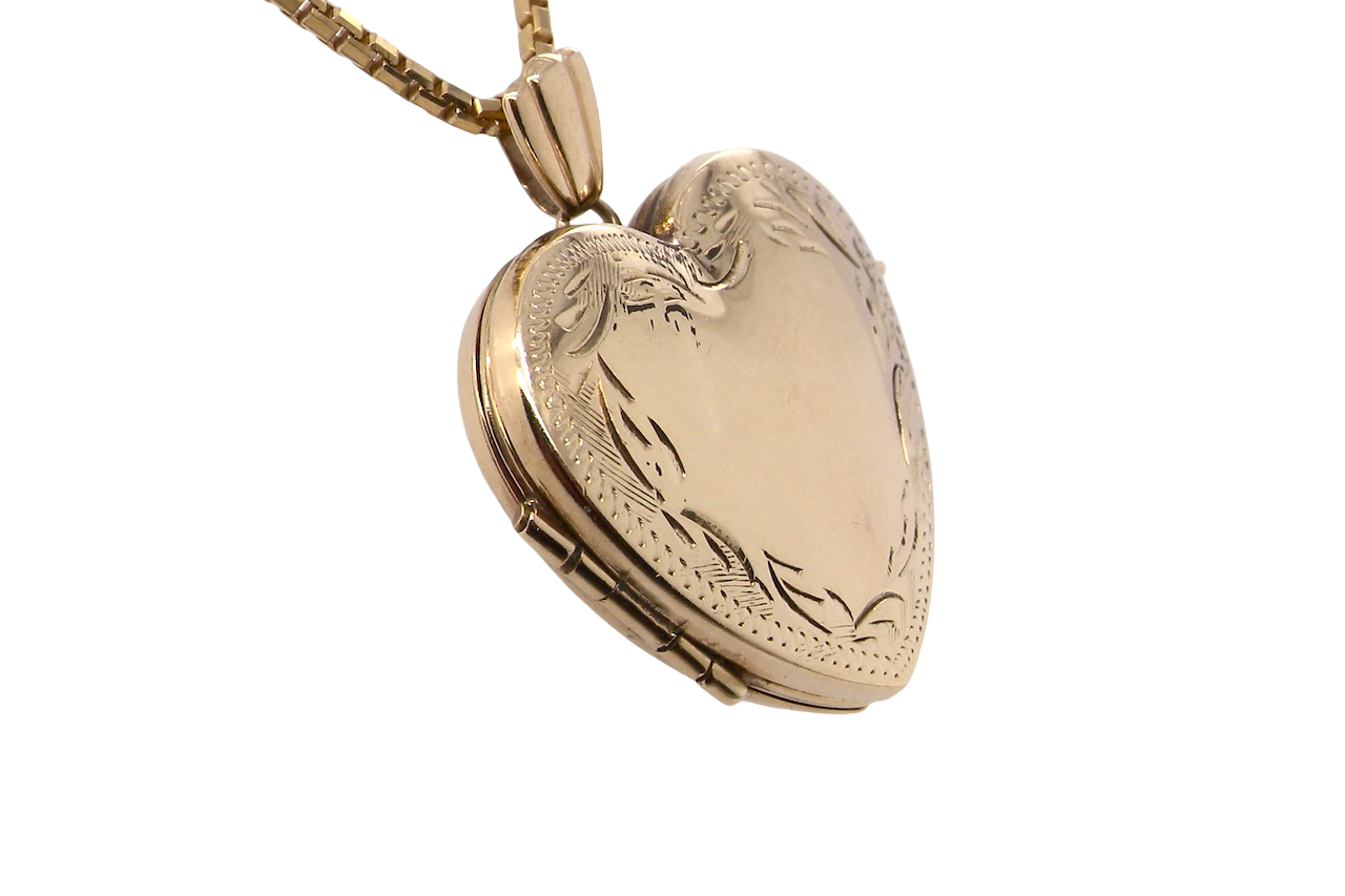 A 9 carat gold heart shaped locket. 25x25mm, part hand engraved front, plain reverse