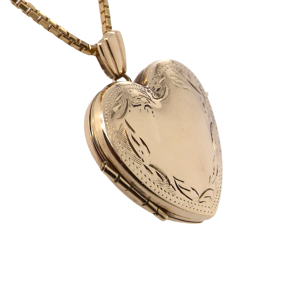 A 9 carat gold heart shaped locket. 25x25mm, part hand engraved front, plain reverse