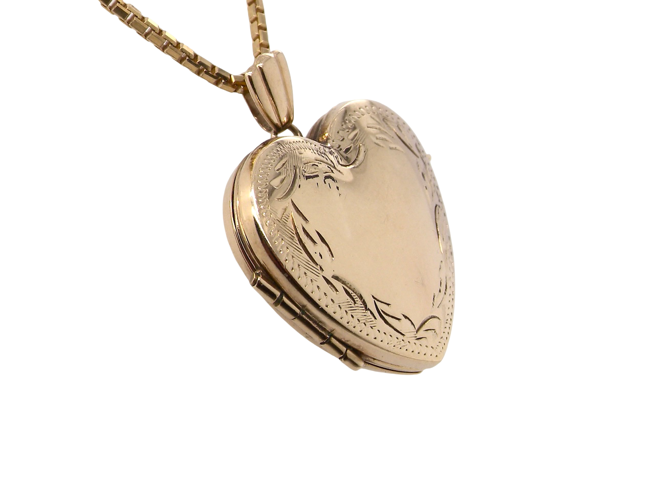 A 9 carat gold heart shaped locket. 25x25mm, part hand engraved front, plain reverse