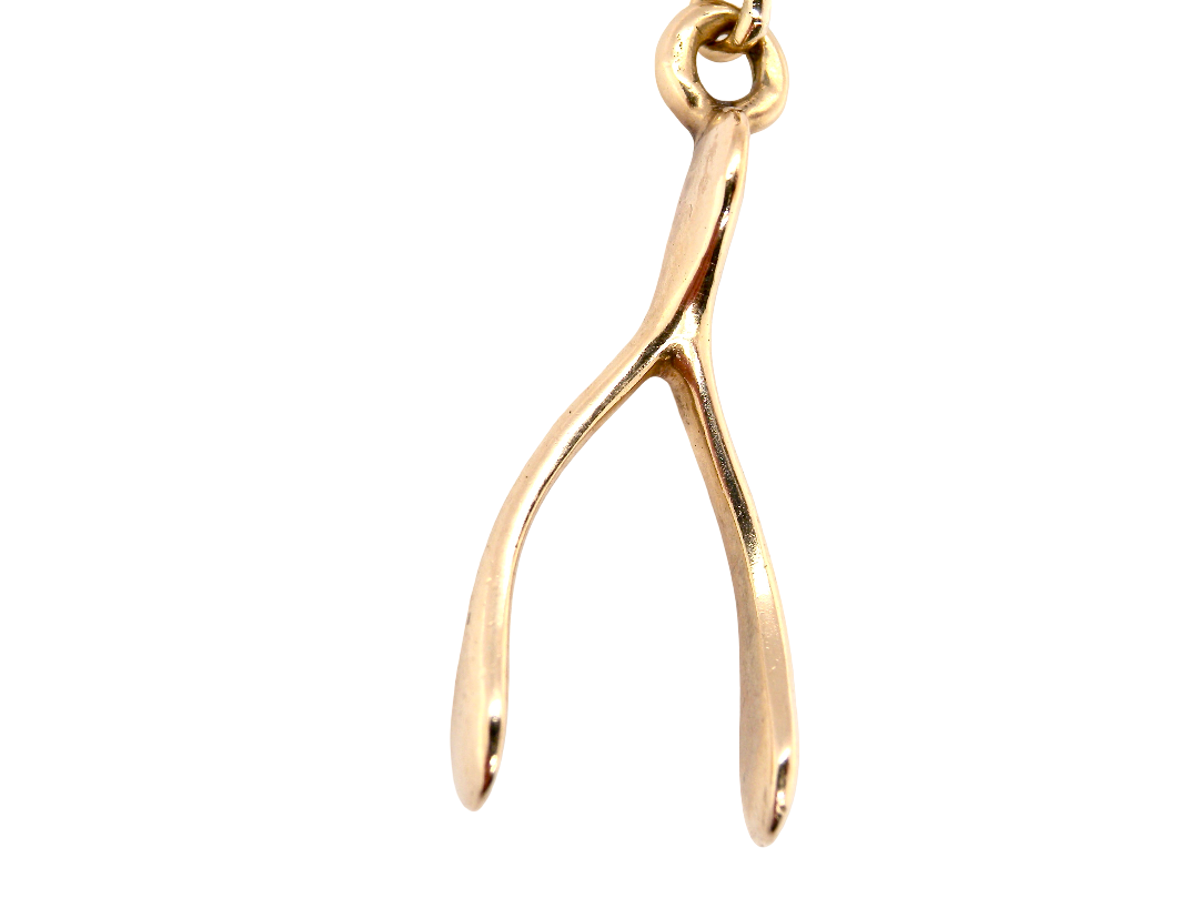 A 9 carat gold pendant (or charm) in the shape of a wishbone.
, weight 3.1 grams. 