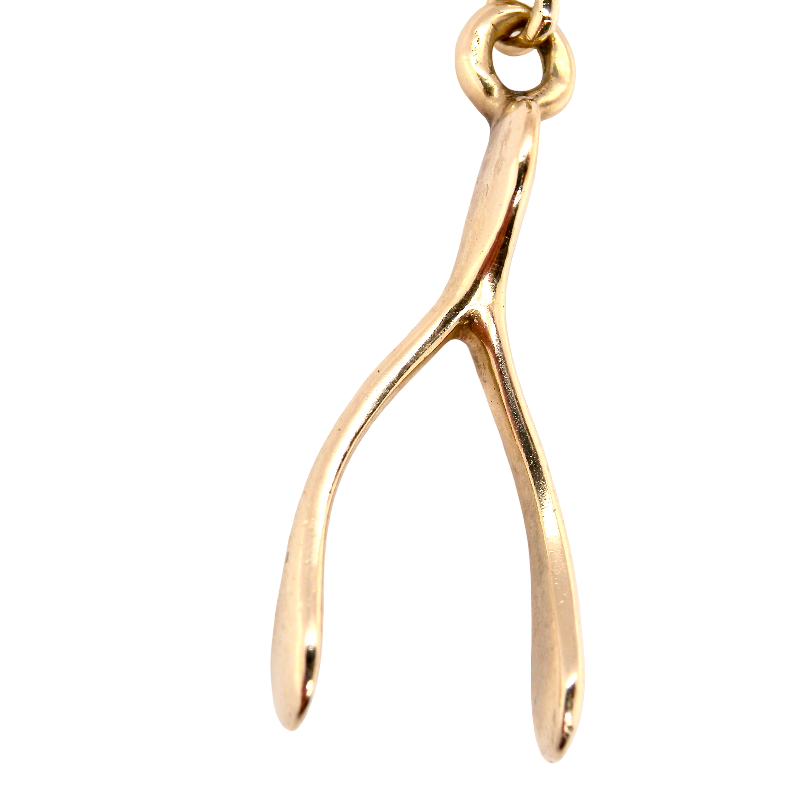 A 9 carat gold pendant (or charm) in the shape of a wishbone.
, weight 3.1 grams. 