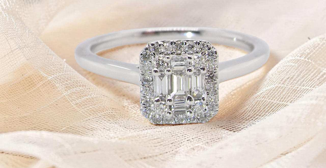 A 9 carat white gold cluster ring. The centre is set with five baguette cut white diamonds,