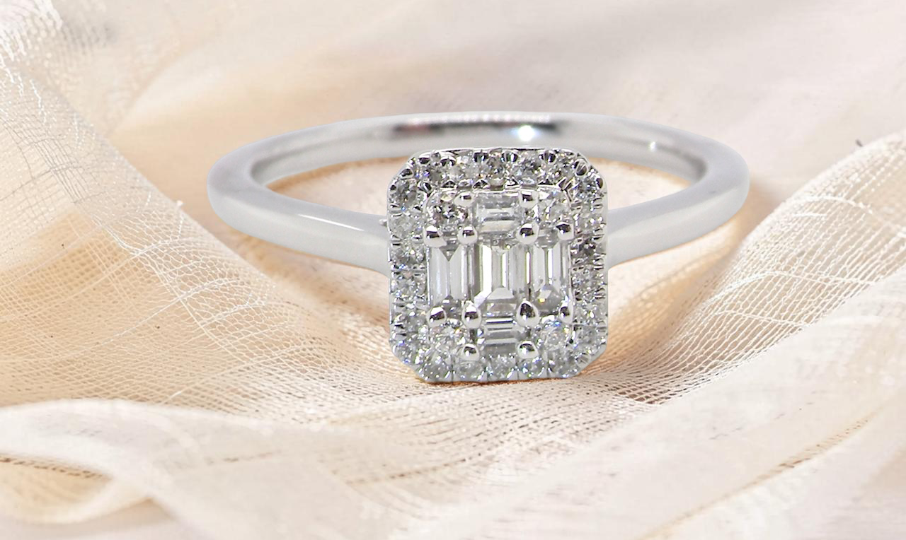 A 9 carat white gold cluster ring. The centre is set with five baguette cut white diamonds,