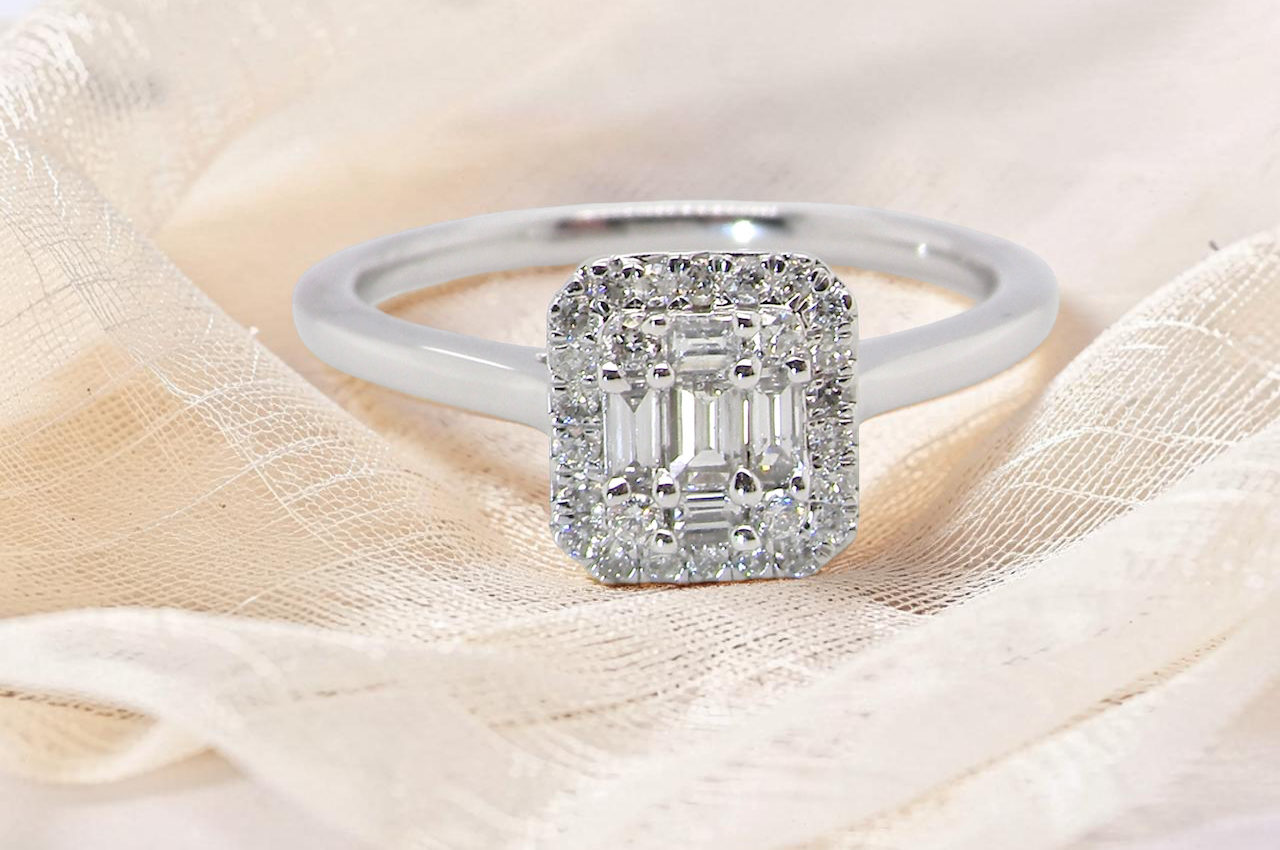 A 9 carat white gold cluster ring. The centre is set with five baguette cut white diamonds,