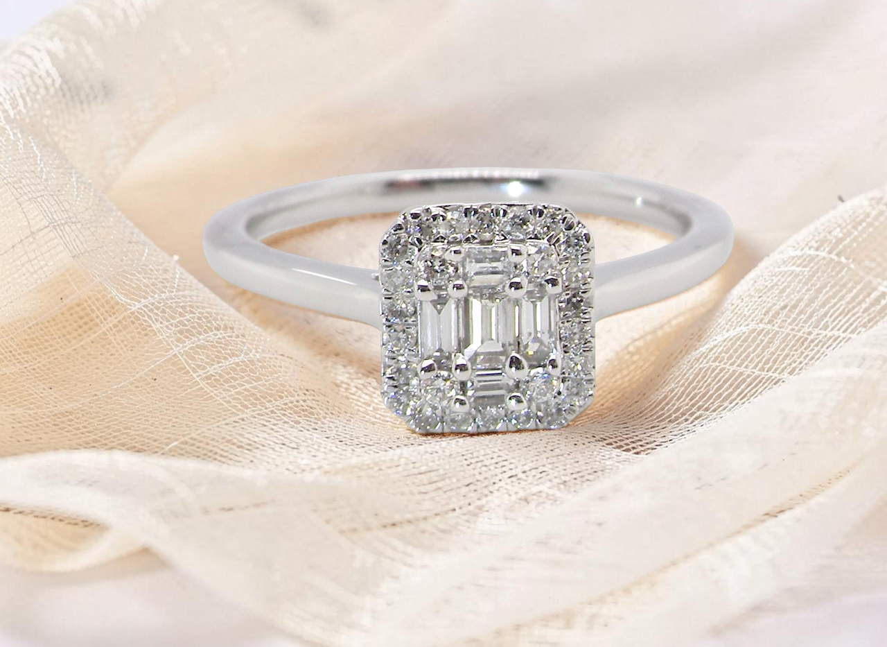 A 9 carat white gold cluster ring. The centre is set with five baguette cut white diamonds,