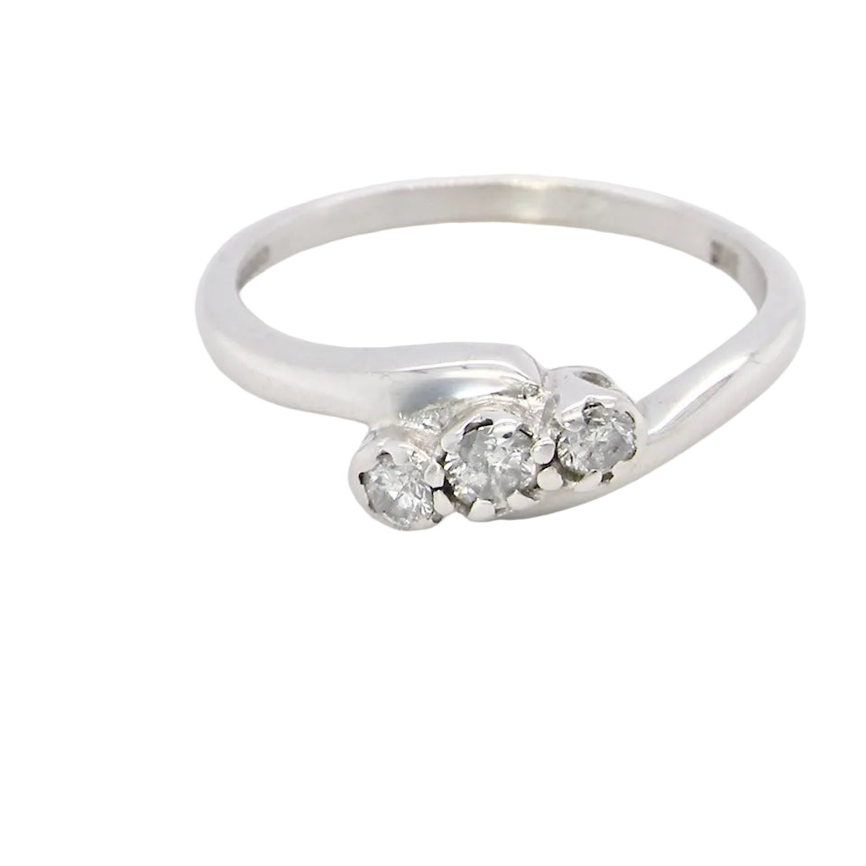 A 9 carat white gold cross over style trilogy ring. Three x 0.10mm diamonds,