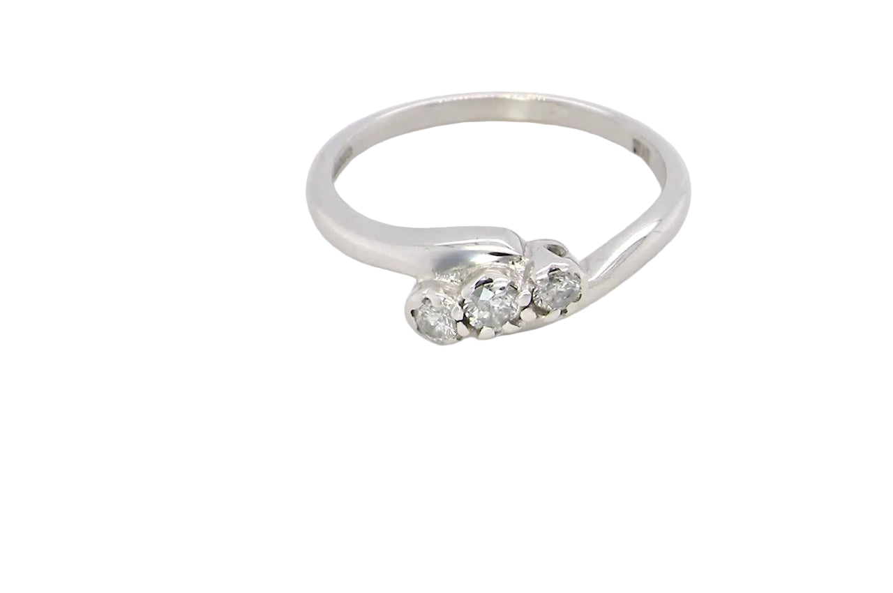 A 9 carat white gold cross over style trilogy ring. Three x 0.10mm diamonds, to an estimated at 0.30 carats.