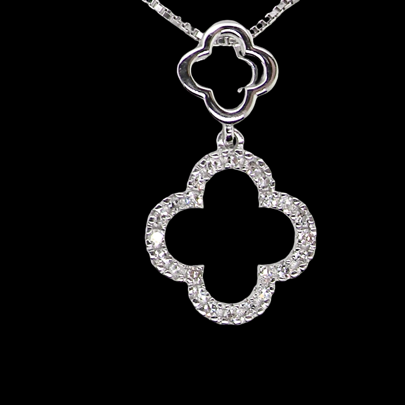 A 9 carat white gold pendant in the 'Alhambra' style. Set with twenty four small diamonds, carat total 0.12 carats.