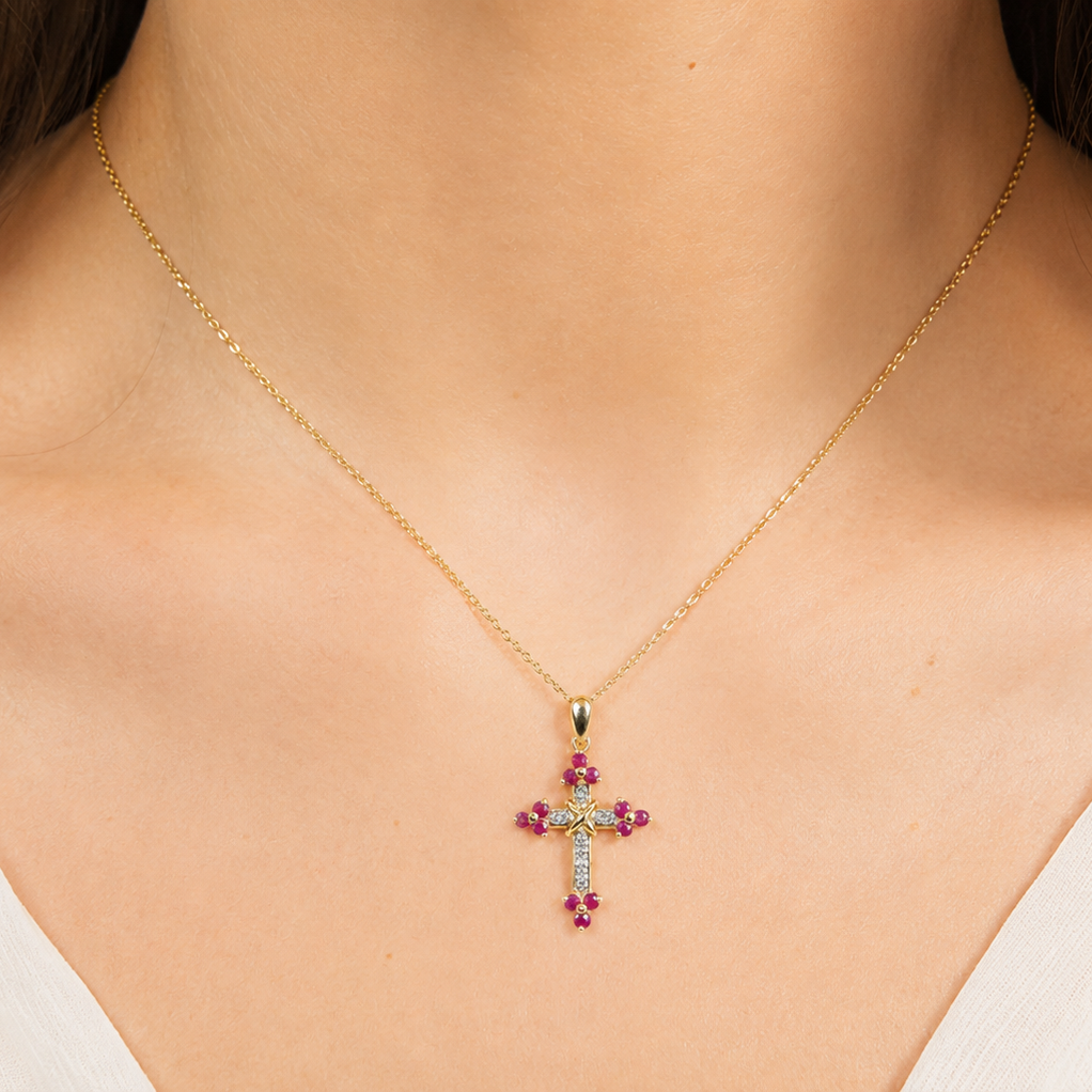 A 9ct gold ruby cross on model