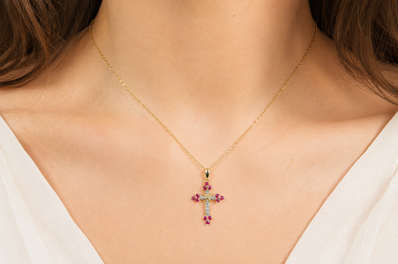 A 9ct gold ruby cross on model