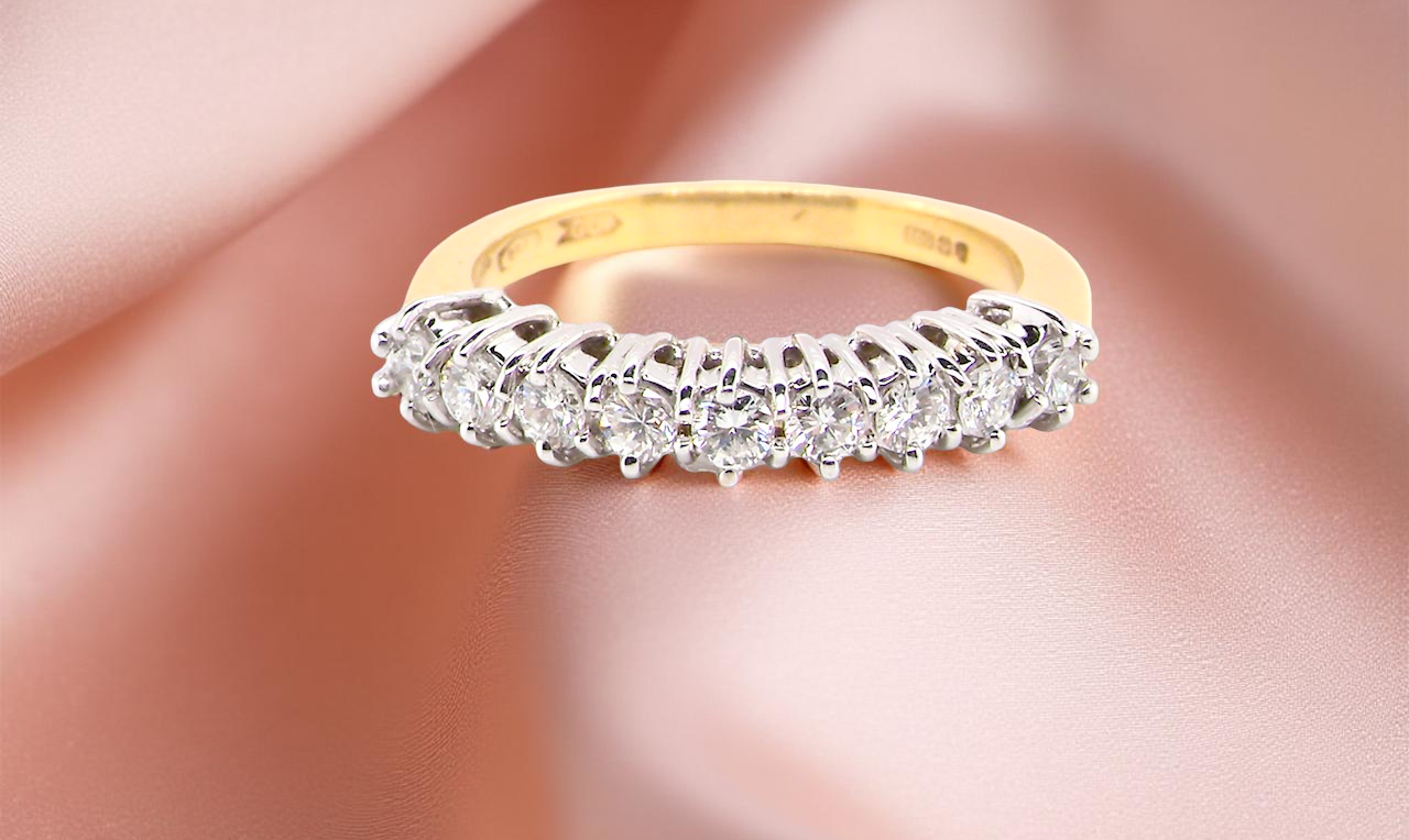 An 18ct gold diamond half eternity ring