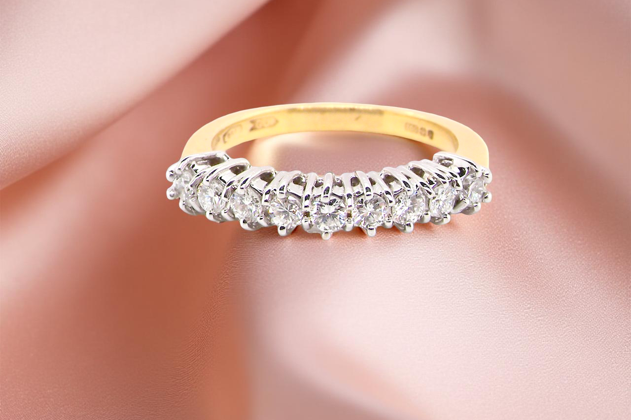 An 18ct gold diamond half eternity ring