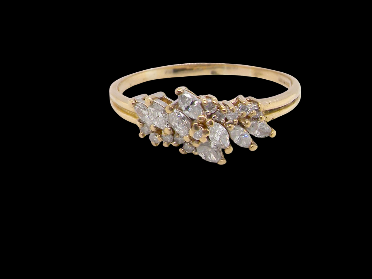 Gold ring with diamond stones on a black background