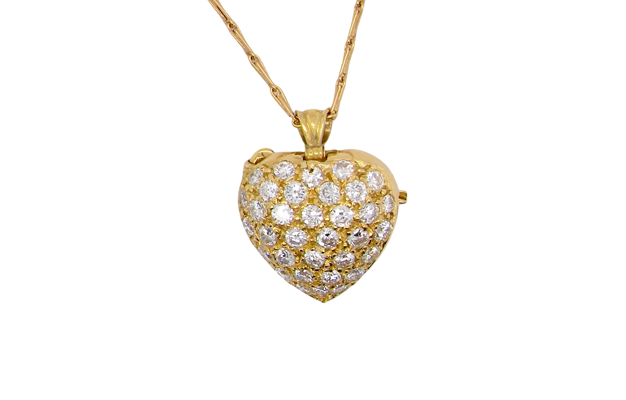 Gold heart-shaped necklace with diamond accents on a white background