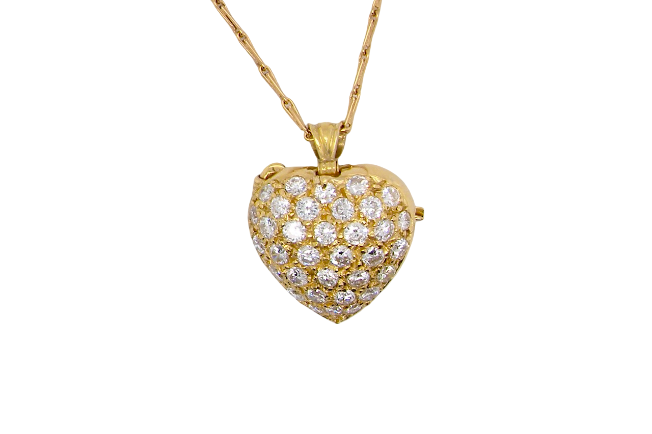 Gold heart-shaped necklace with diamond accents on a white background