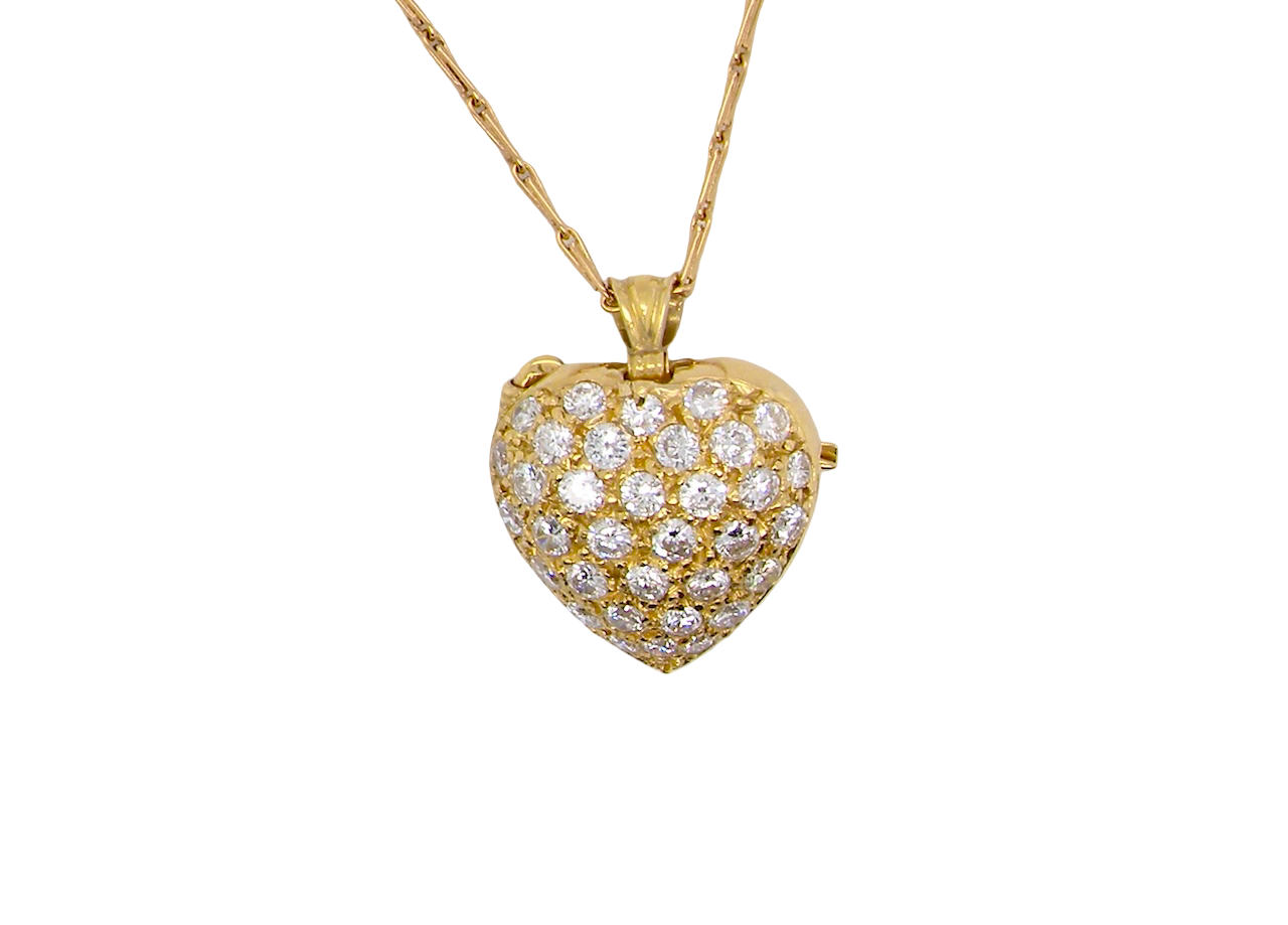 Gold heart-shaped necklace with diamond accents on a white background