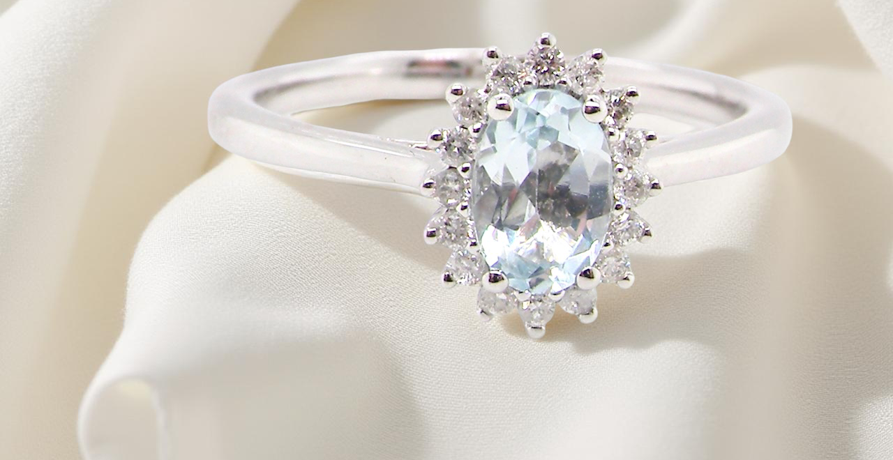 A NEW blue topaz and diamond ring