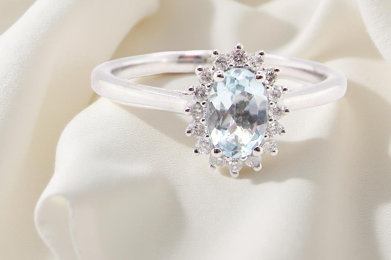 A NEW blue topaz and diamond ring