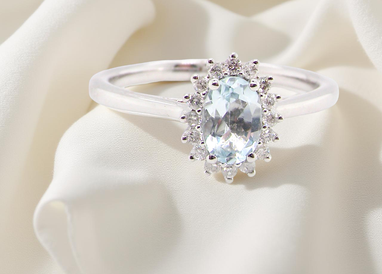 A NEW blue topaz and diamond ring