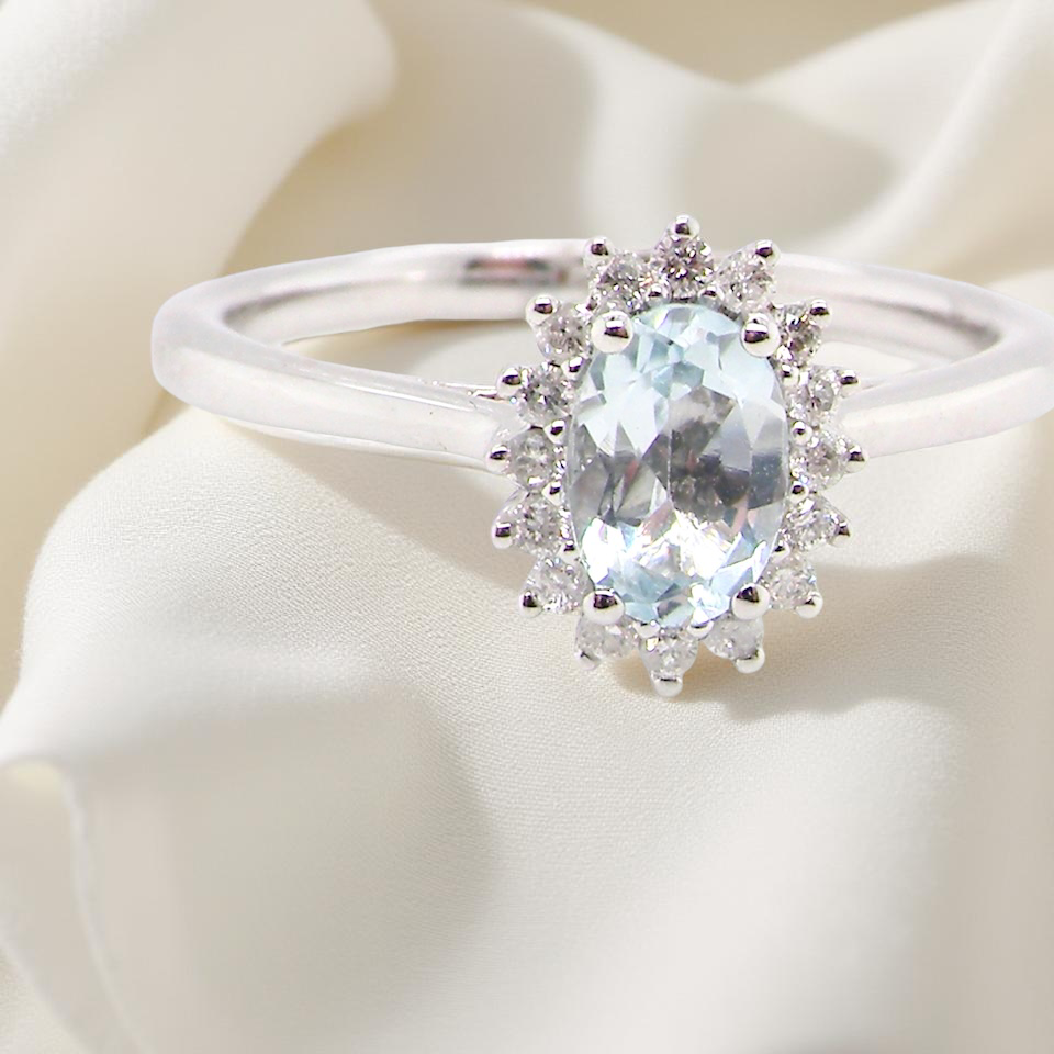 A NEW blue topaz and diamond ring