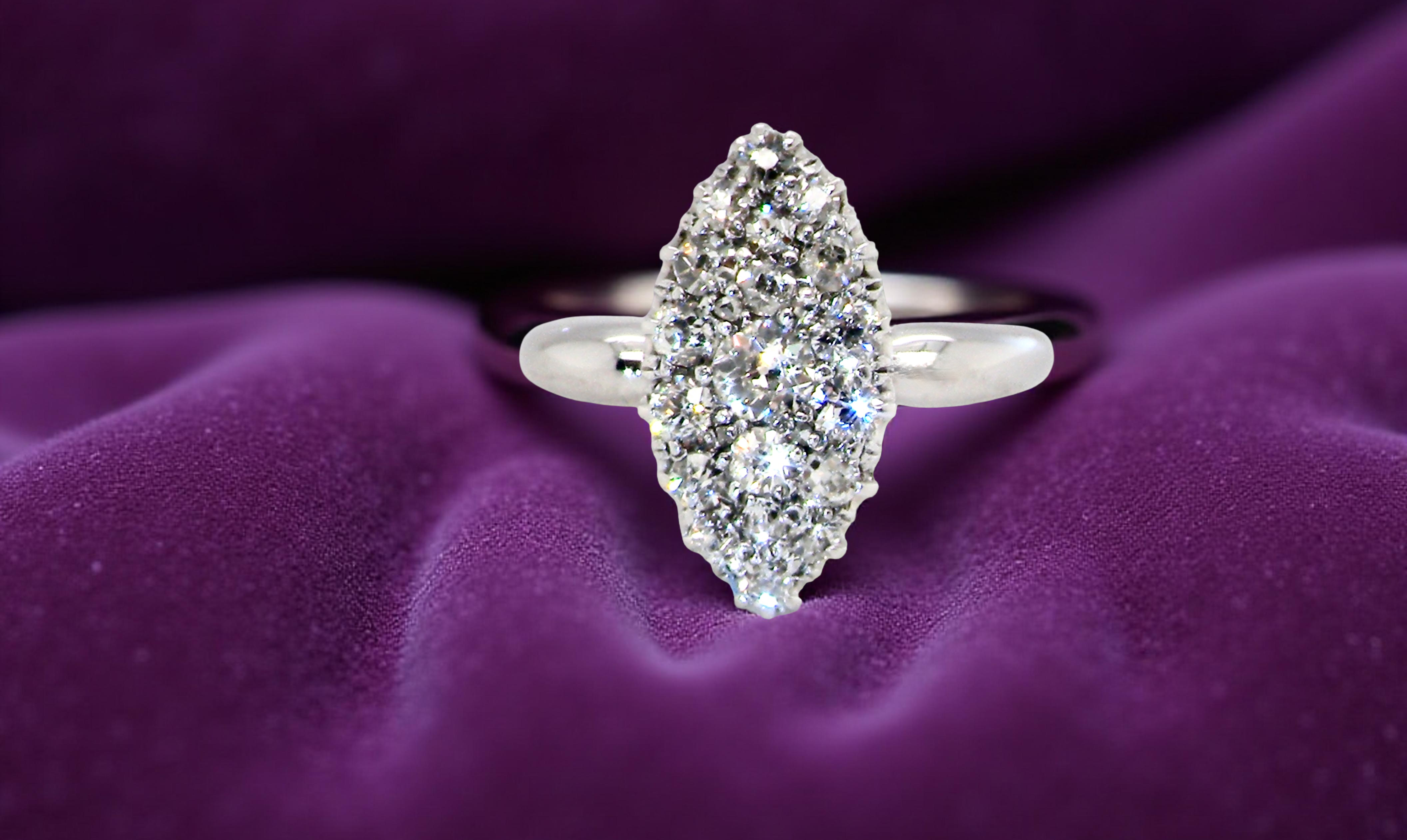 A Stunning Marquise Cluster Diamond Ring purple background