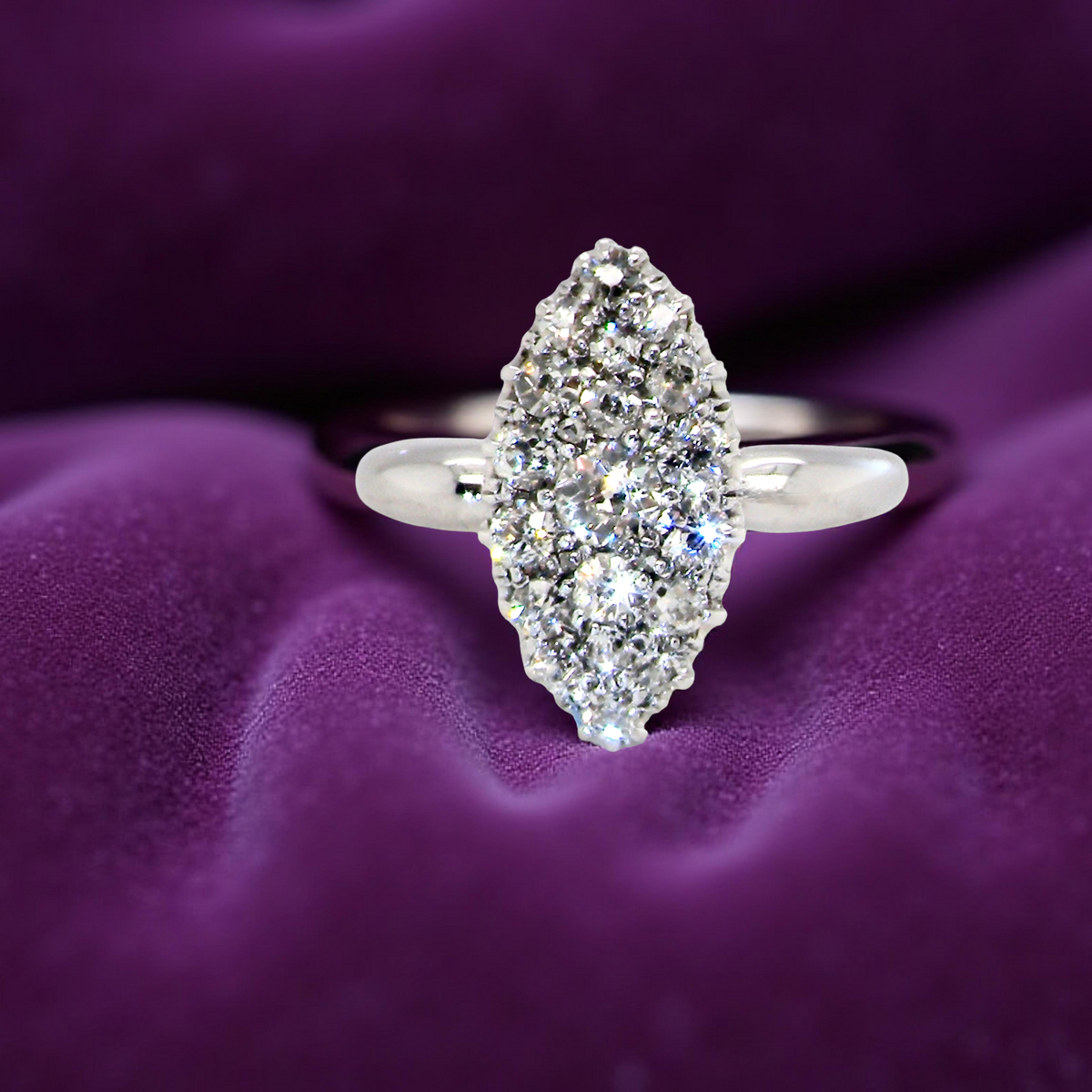 A Stunning Marquise Cluster Diamond Ring purple background