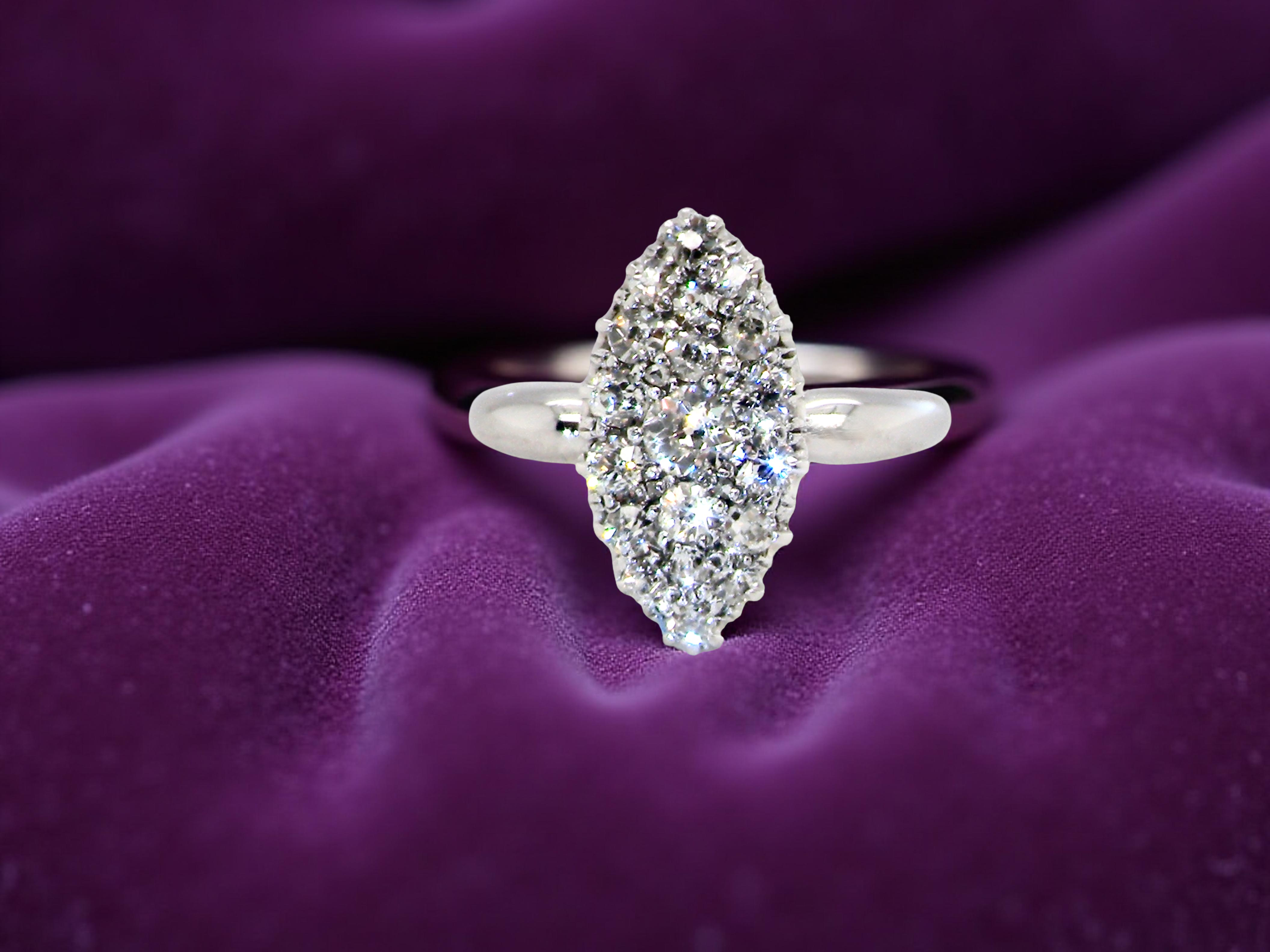 A Stunning Marquise Cluster Diamond Ring purple background