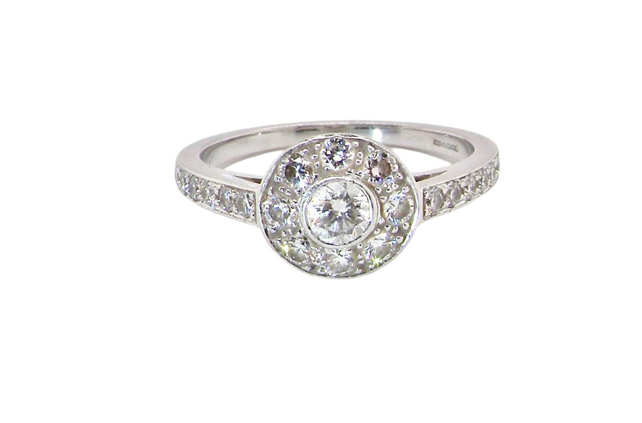 A target cluster diamond ring with a principal diamond surrounded by smaller ones, set in platinum.