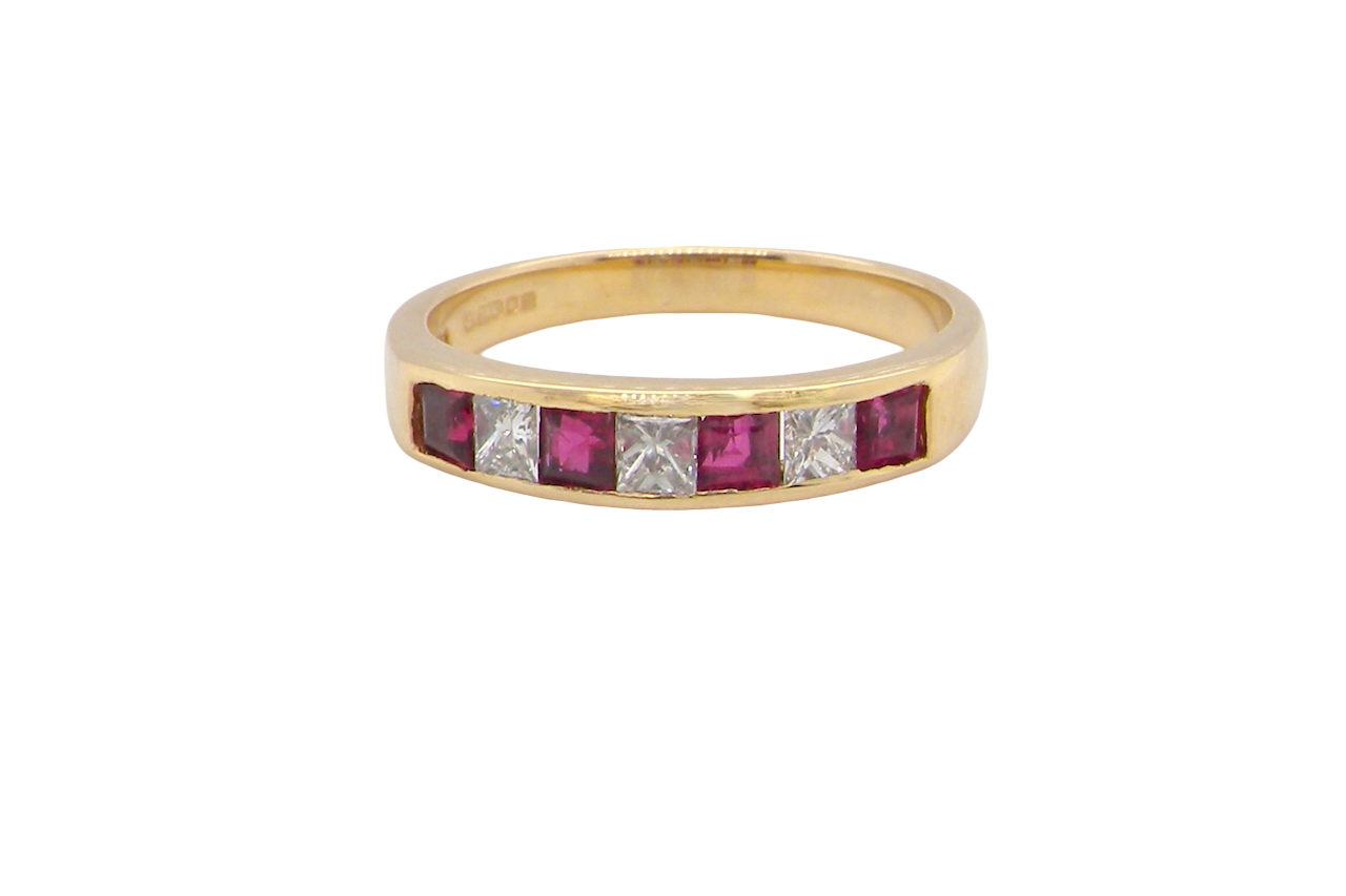 A beautiful 18-carat gold half-hoop eternity ring set with alternating rubies and diamonds.