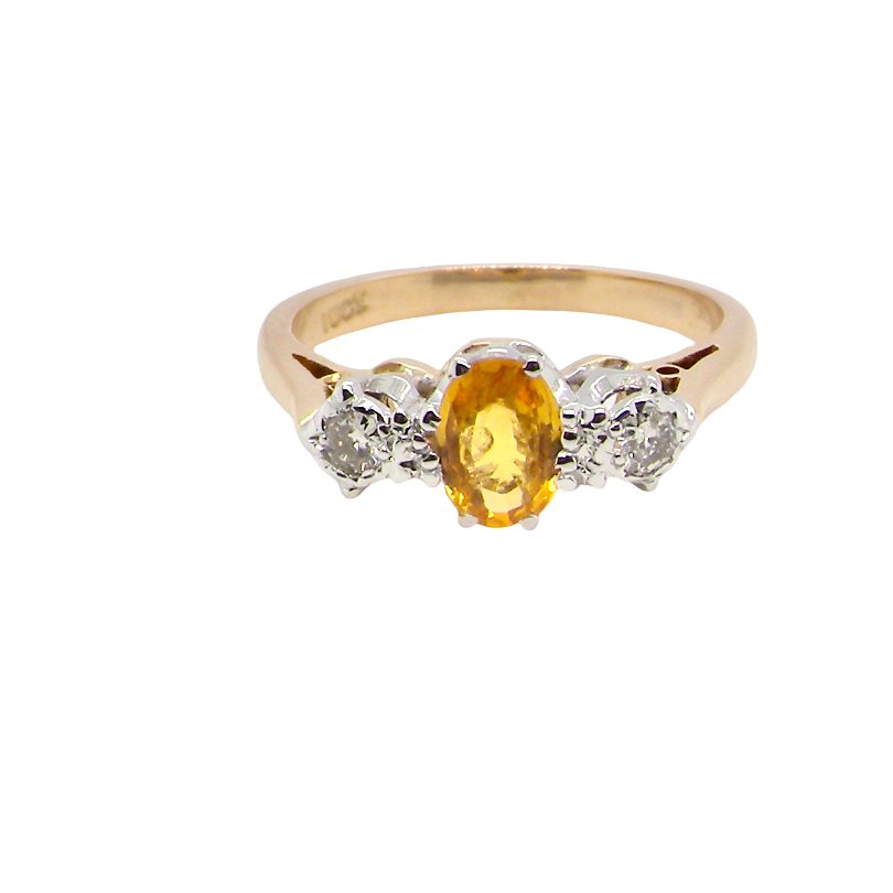 A yellow gold ring featuring an oval-cut yellow center stone flanked by three small round clear stones in a silver-colored setting, shown against a plain white background.