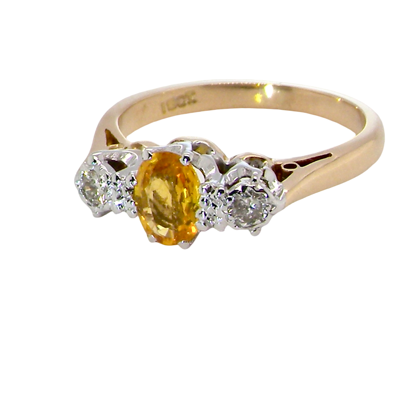 A beautiful 18 carat yellow gold trilogy ring, combining the warm golden tones of a yellow sapphire with white diamonds. side