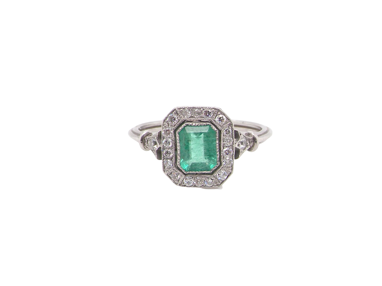 A beautiful Art Deco cluster ring centred with a vibrant step-cut emerald