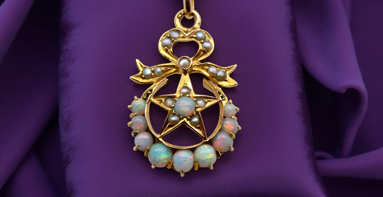 An antique Victorian pendant featuring opals and pearl