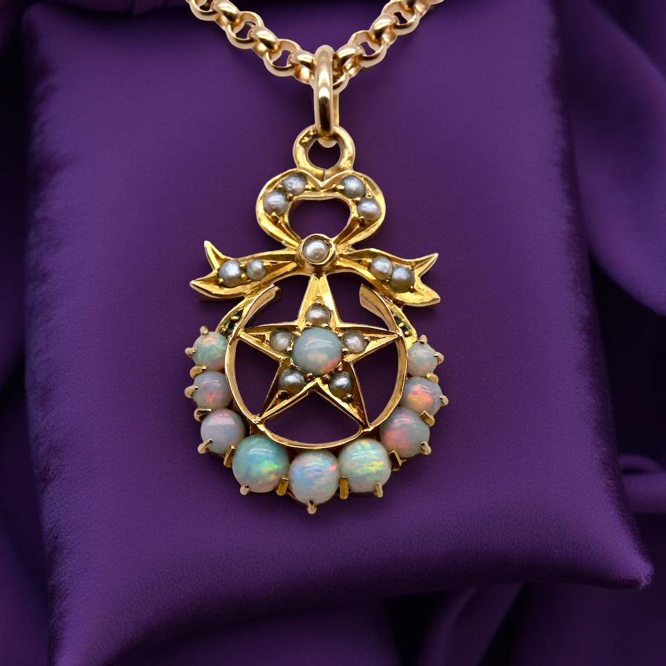 An antique Victorian pendant featuring opals and pearl