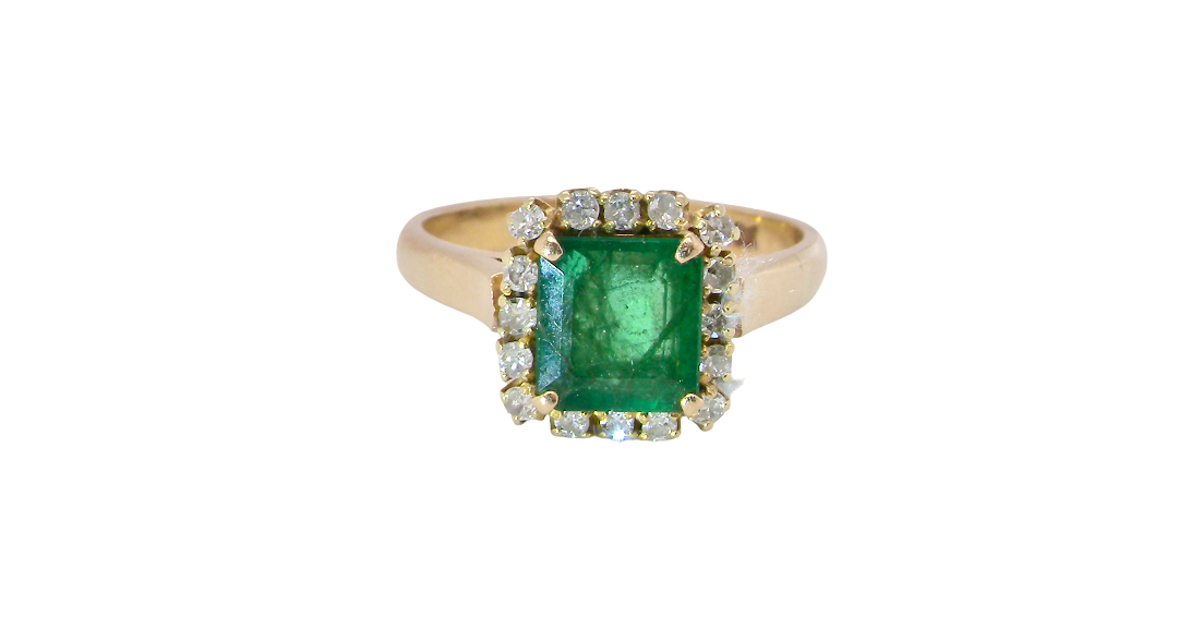 A beautiful cluster ring set with a large square-cut emerald measuring approximately 7 x 7mm, displaying a deep grass-green colour with natural inclusions, as expected in emeralds.