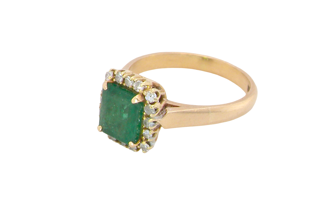 A beautiful cluster ring set with a large square-cut emerald measuring approximately 7 x 7mm, displaying a deep grass-green colour with natural inclusions, as expected in emeralds. side