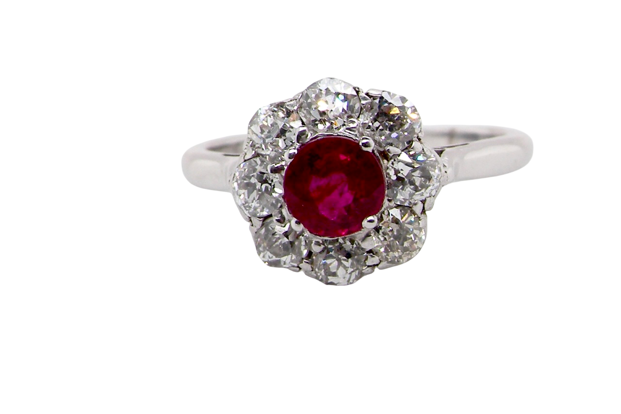 A beautiful cluster ring set with a raspberry-red ruby centre stone 0.50 carats.
