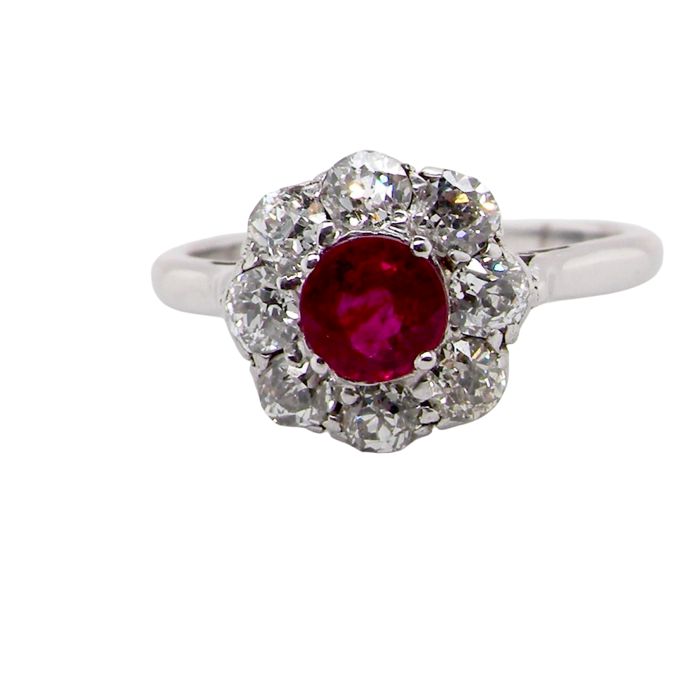 A beautiful cluster ring set with a raspberry-red ruby centre stone 0.50 carats.