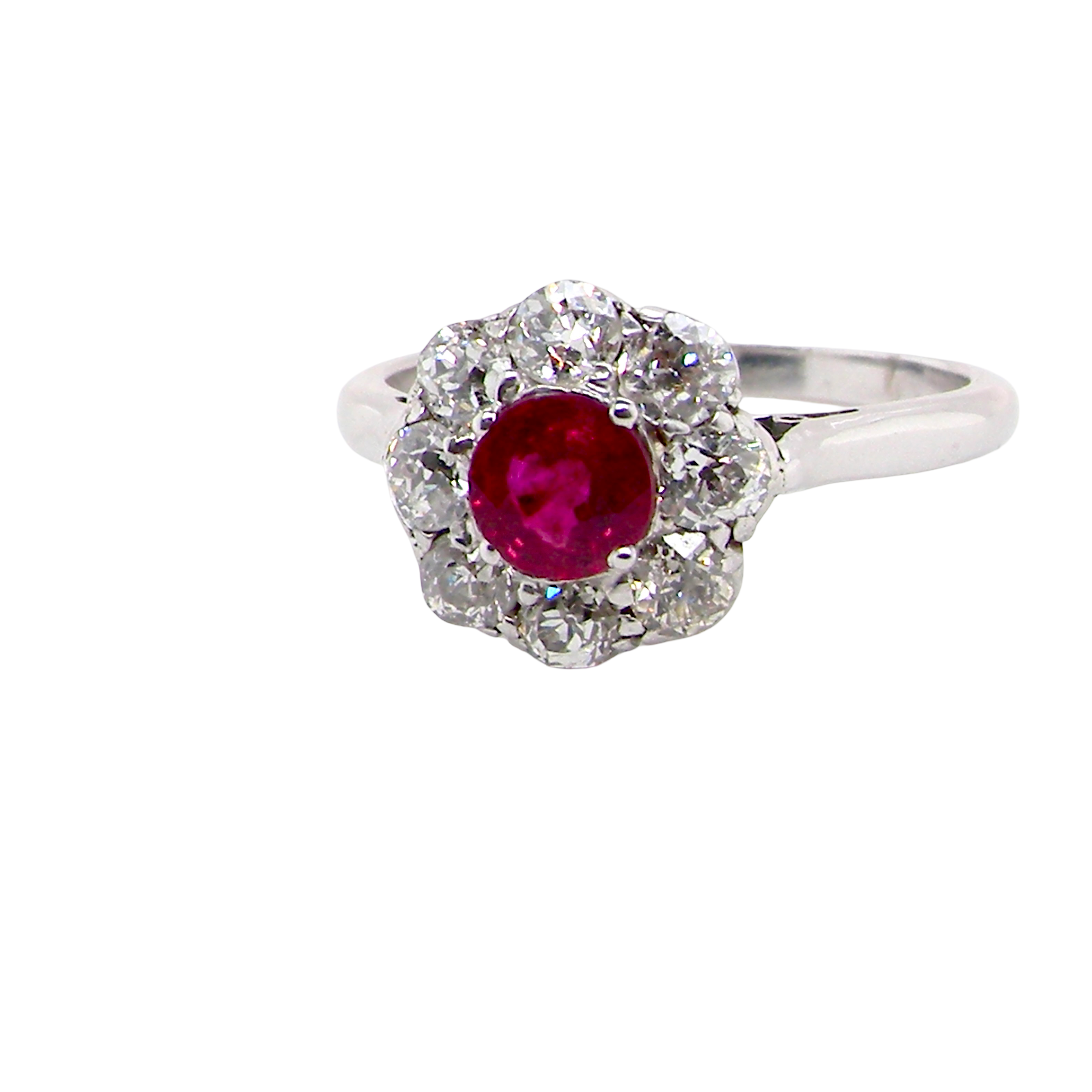 A beautiful cluster ring set with a raspberry-red ruby centre stone measuring 5mm in diameter, estimated at approximately 0.50 carats.