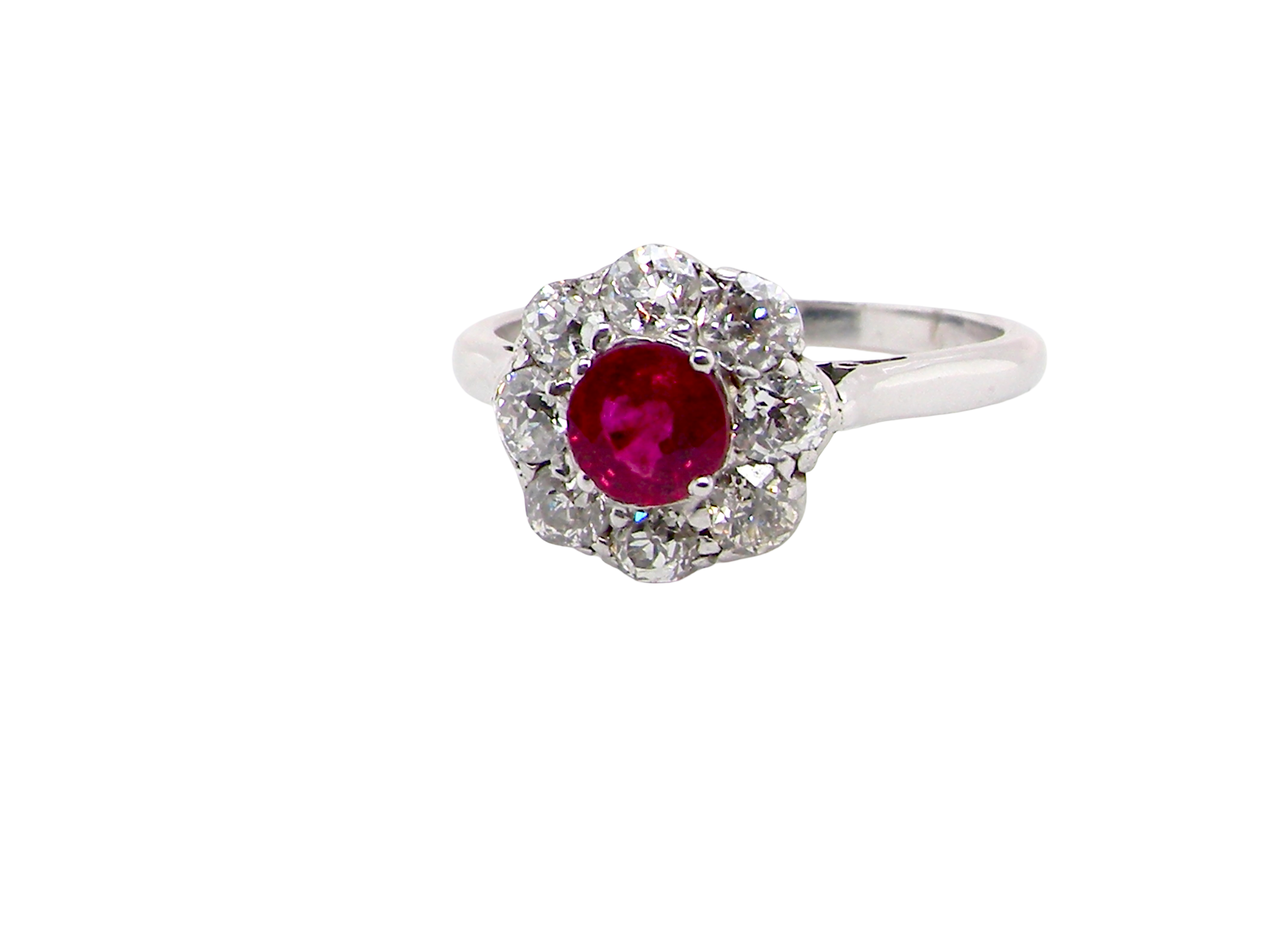 A beautiful cluster ring set with a raspberry-red ruby centre stone measuring 5mm in diameter, estimated at approximately 0.50 carats.