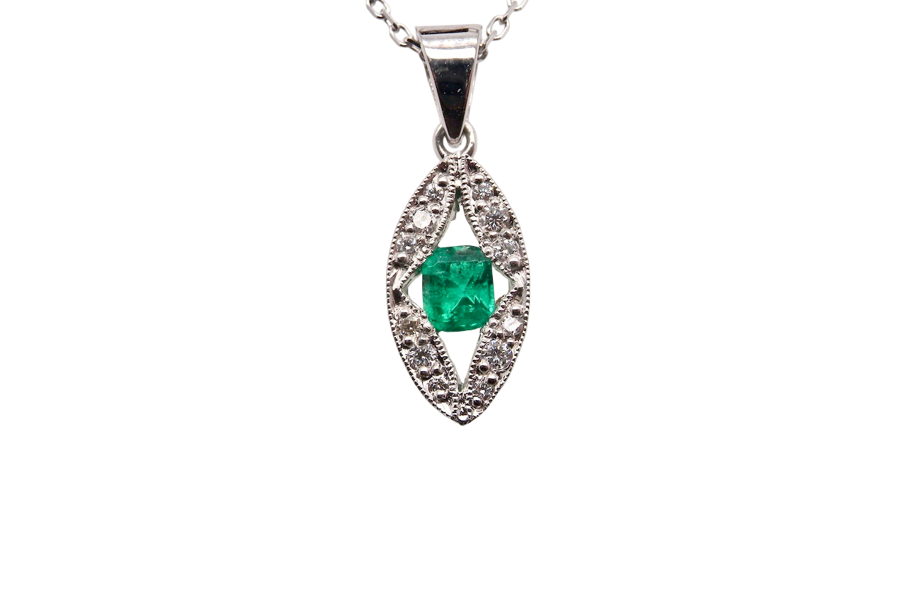 A beautiful modern 18ct white gold pendant featuring a cushion-cut emerald measuring approximately 4 x 3.5mm , displaying a rich deep grass-green hue.