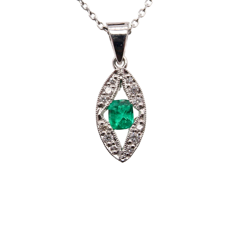 A beautiful modern 18ct white gold pendant featuring a cushion-cut emerald measuring approximately 4 x 3.5mm , displaying a rich deep grass-green hue.