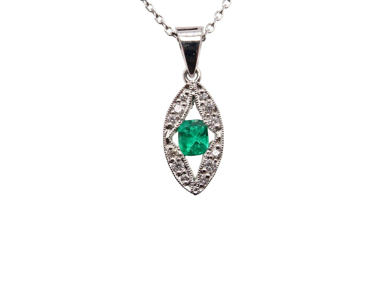A beautiful modern 18ct white gold pendant featuring a cushion-cut emerald measuring approximately 4 x 3.5mm , displaying a rich deep grass-green hue.