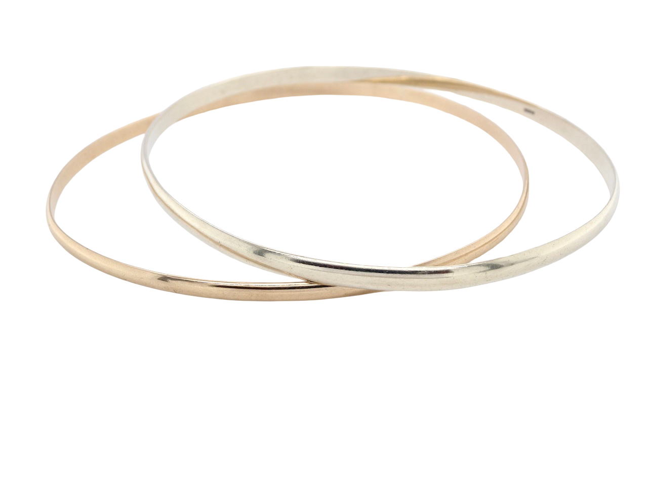 A beautiful pair of solid 9 carat gold bangles, featuring one in white gold and one in yellow gold. These classic circular bangles are timeless, elegant pieces that can be worn individually or stacked together for a contemporary layered look.
