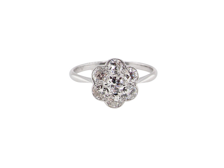 Diamond ring with floral design on a white background